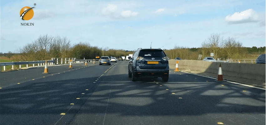 green reflective road studs on motorway